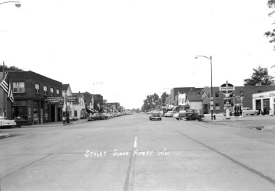 Historical street with cars and buildings on either side